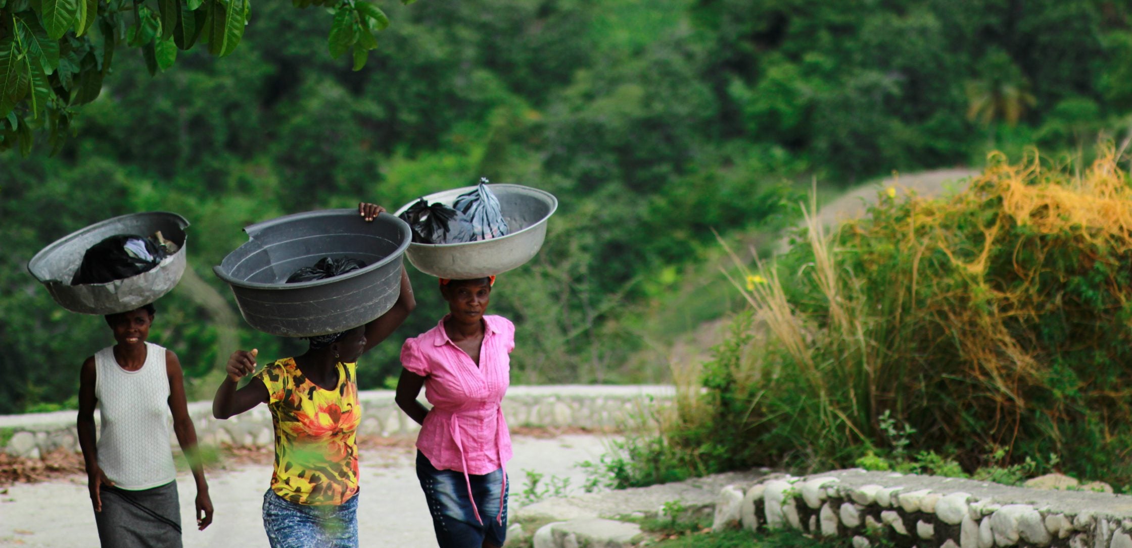 Women carrying buckets on their heads