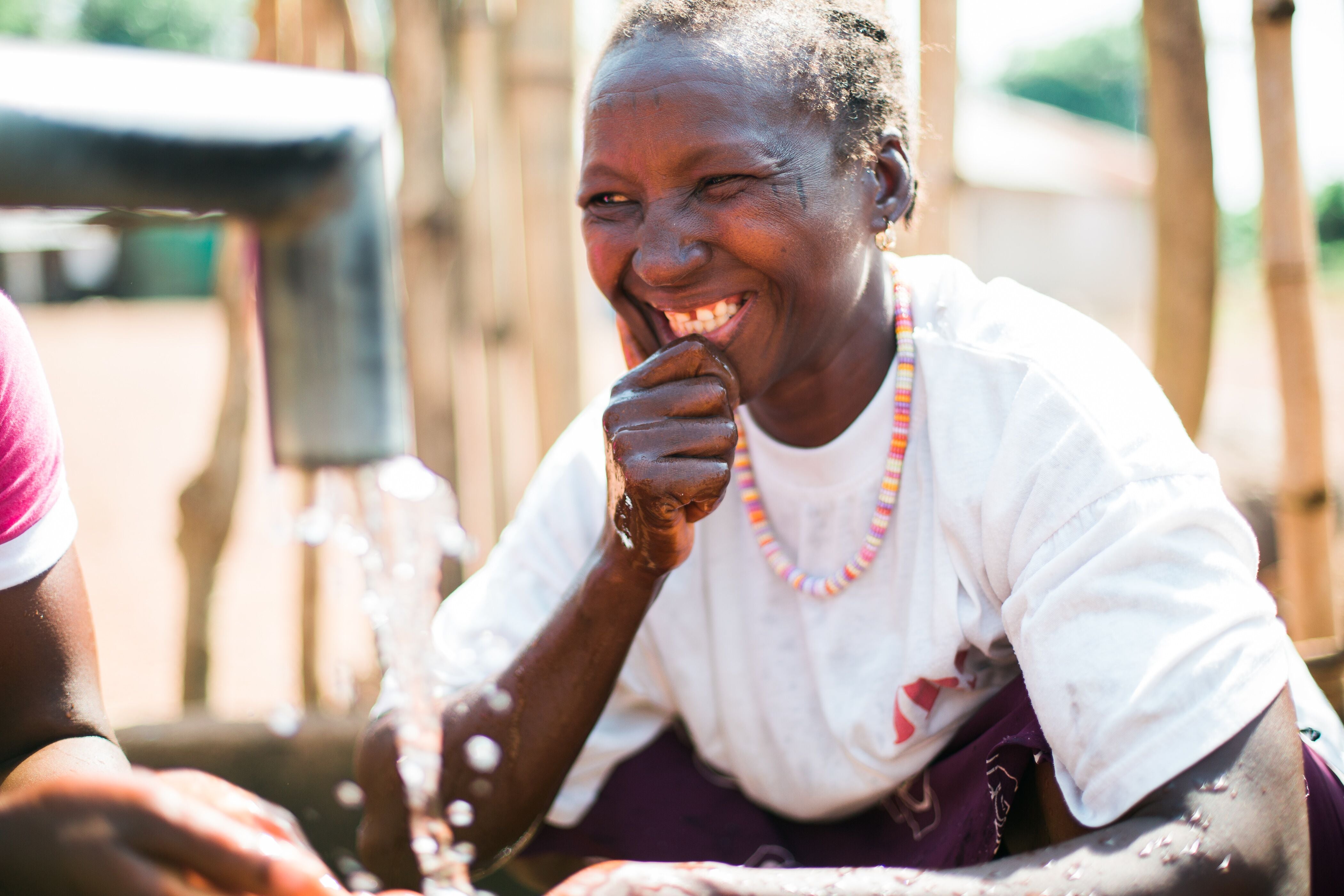 Woman drinking water from tap