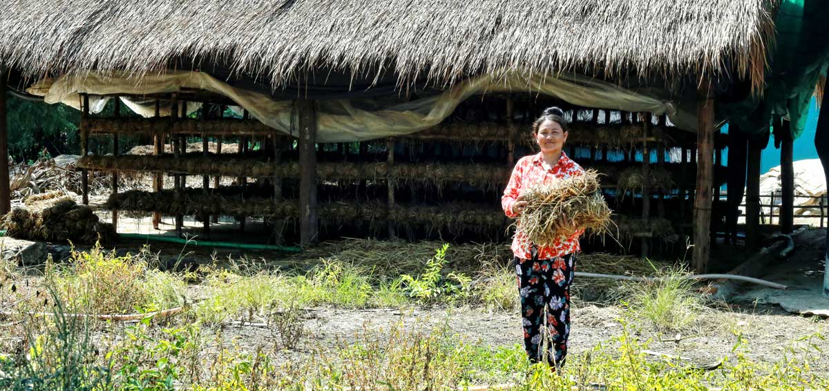 Woman in front of her mushroom house