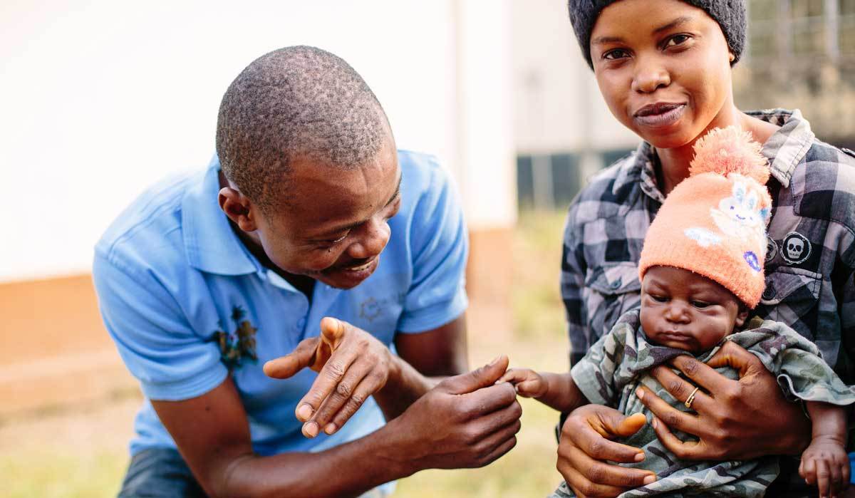 Mom with her baby and world hope worker