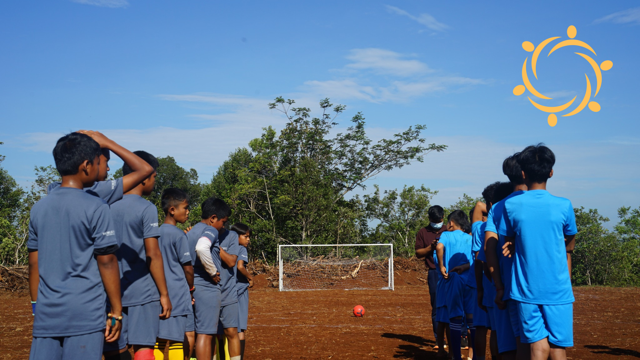 Kids playing soccer, lined up at the net to take shots