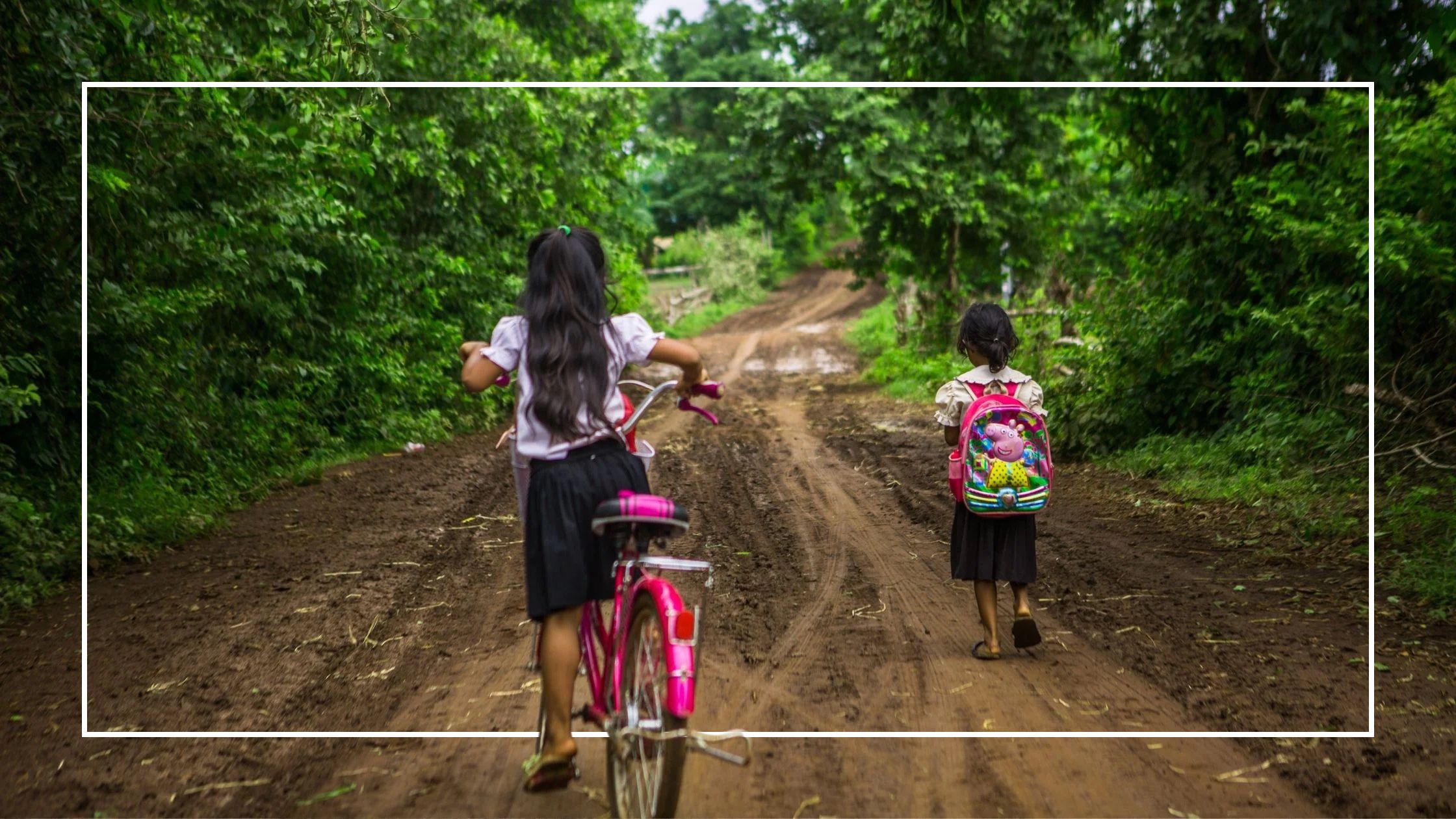 Girls going to school on bike and by foot