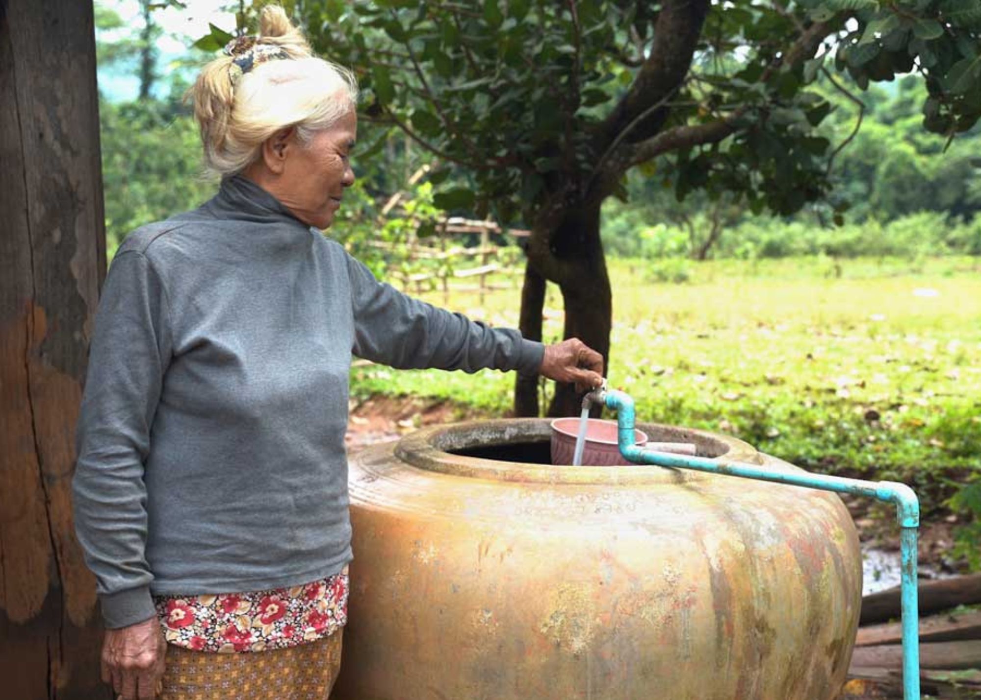Woman filling cistern