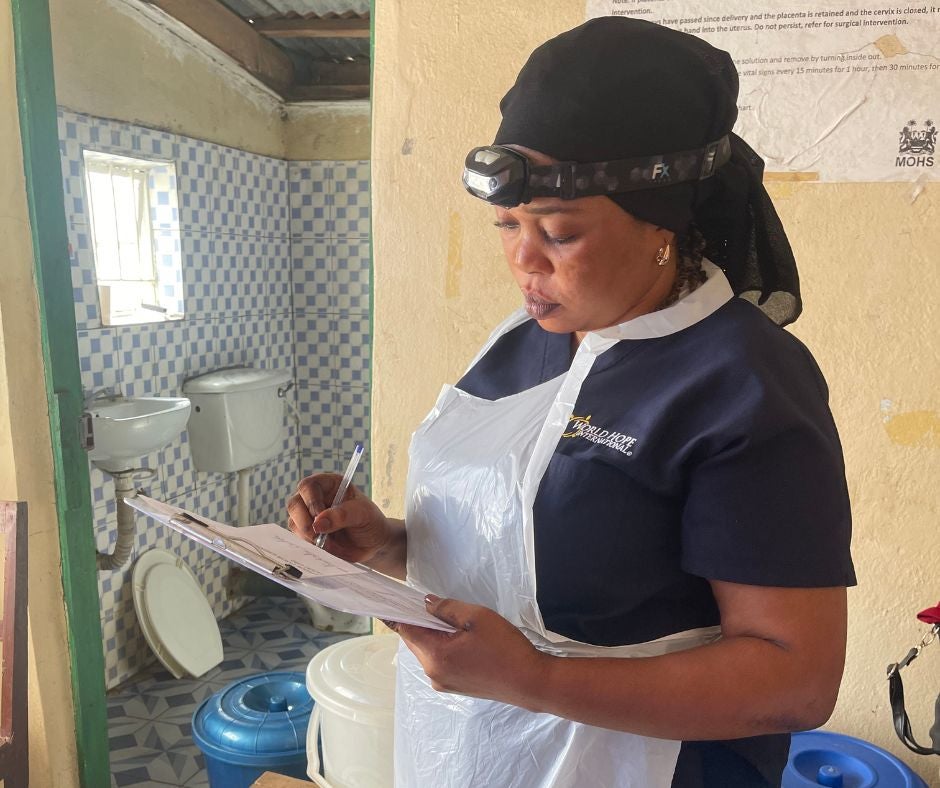 Nurse reading a chart at cervical cancer screening clinic
