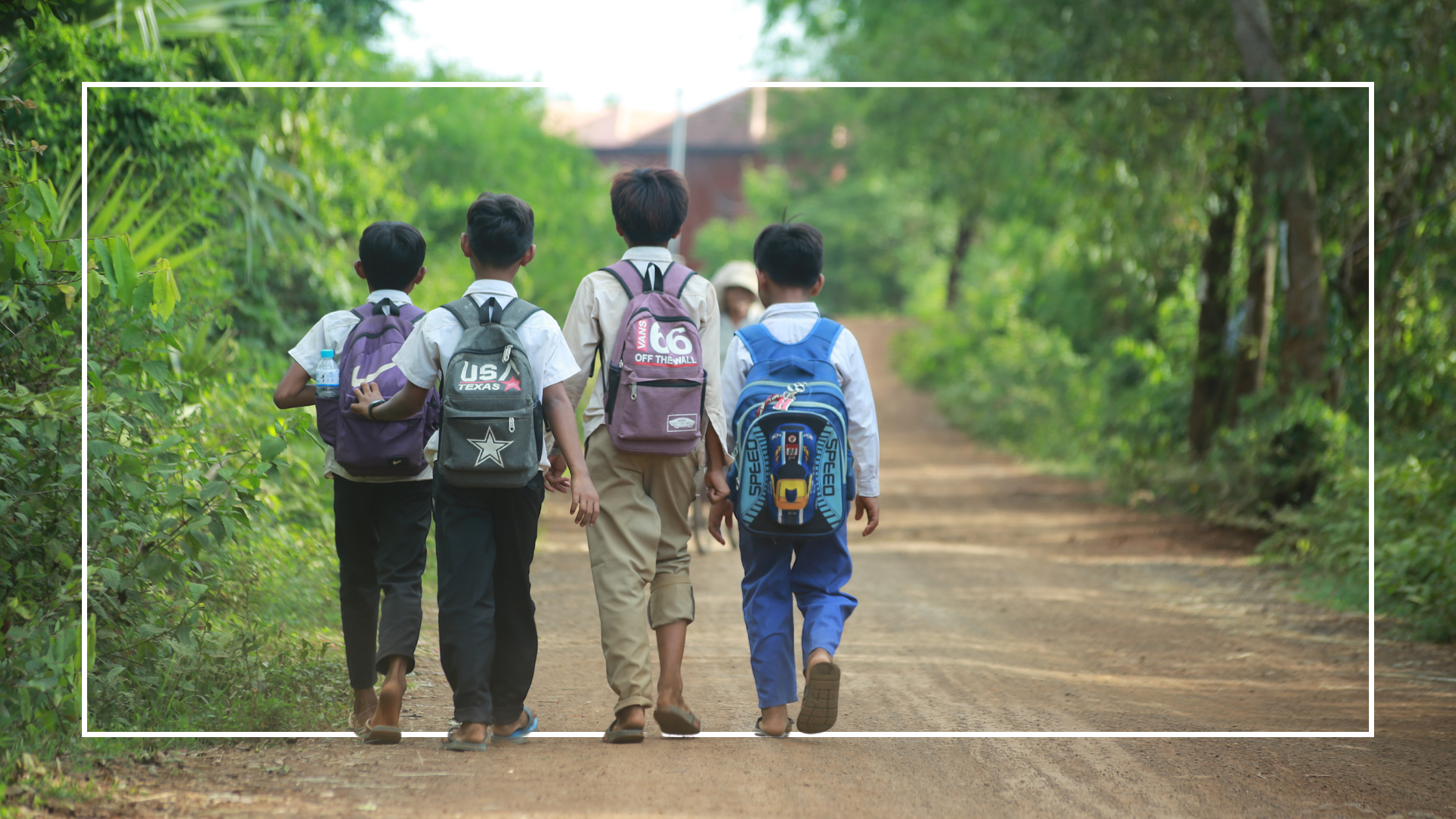 Boys walking down a rural road to school