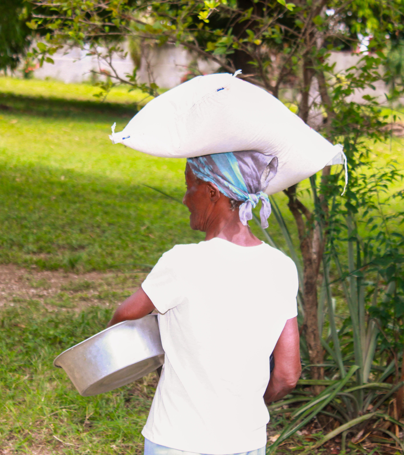 Haitian woman with a bag of rice on her head