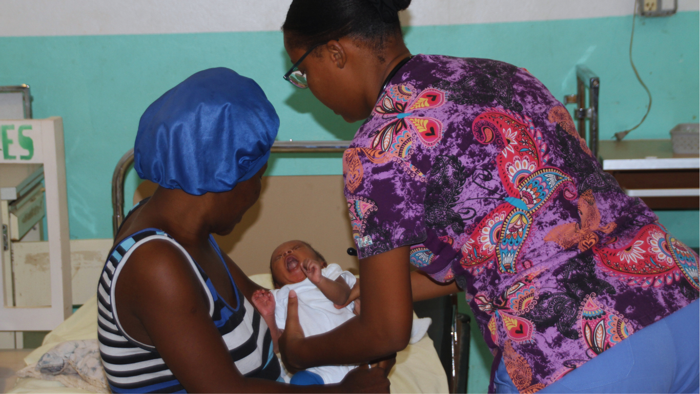 Mother and baby being cared for by a nurse at La Gonave Hospital 