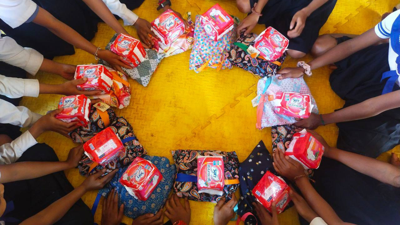 Girls in Cambodia receiving menses supplies