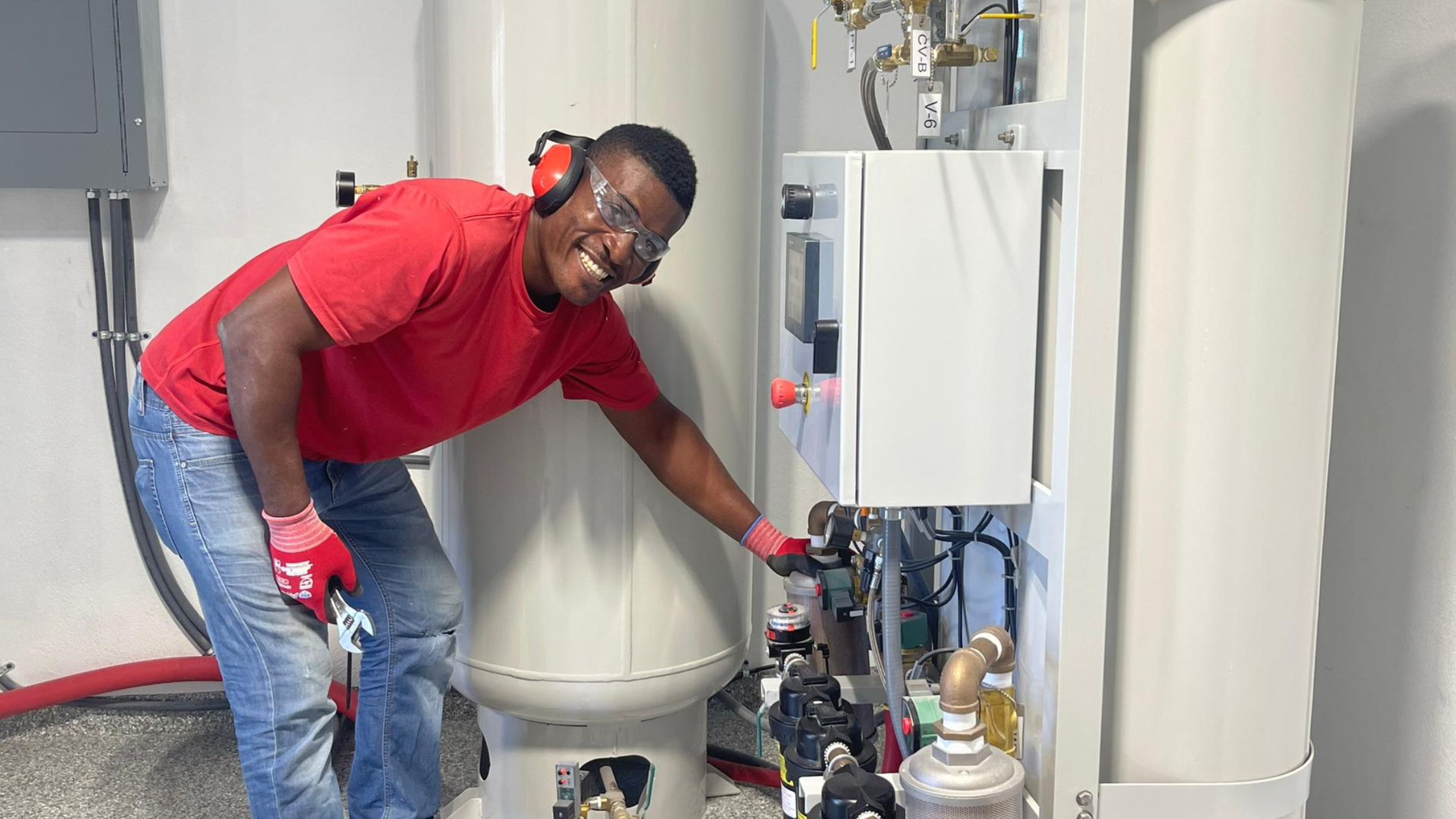 Man showing off newly installed O2 generation plant in Haiti hospital