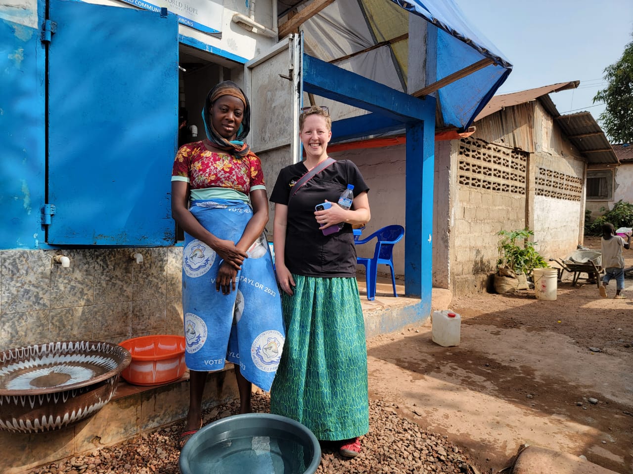 Tanya with lady at water Kiosk in Liberia