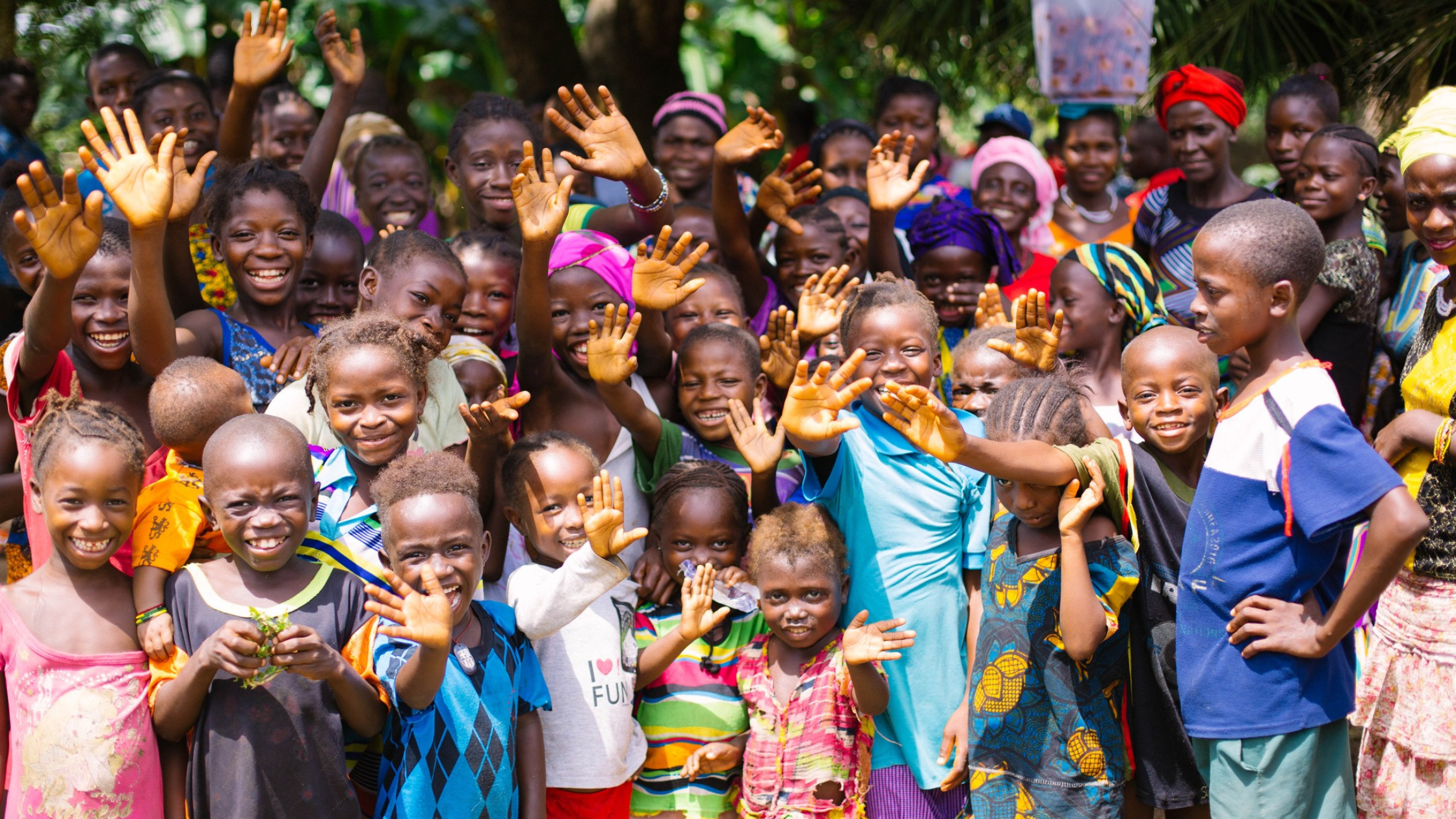 Smiling and waving children and adults