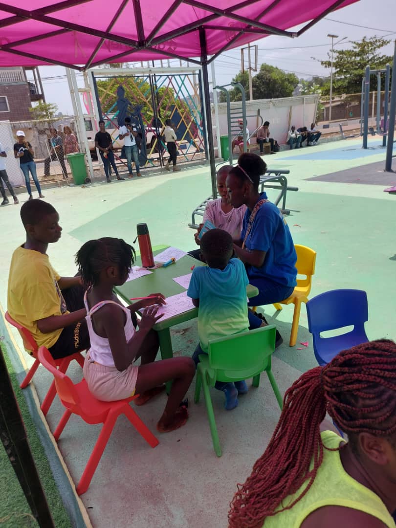 Genda teaching a group of children