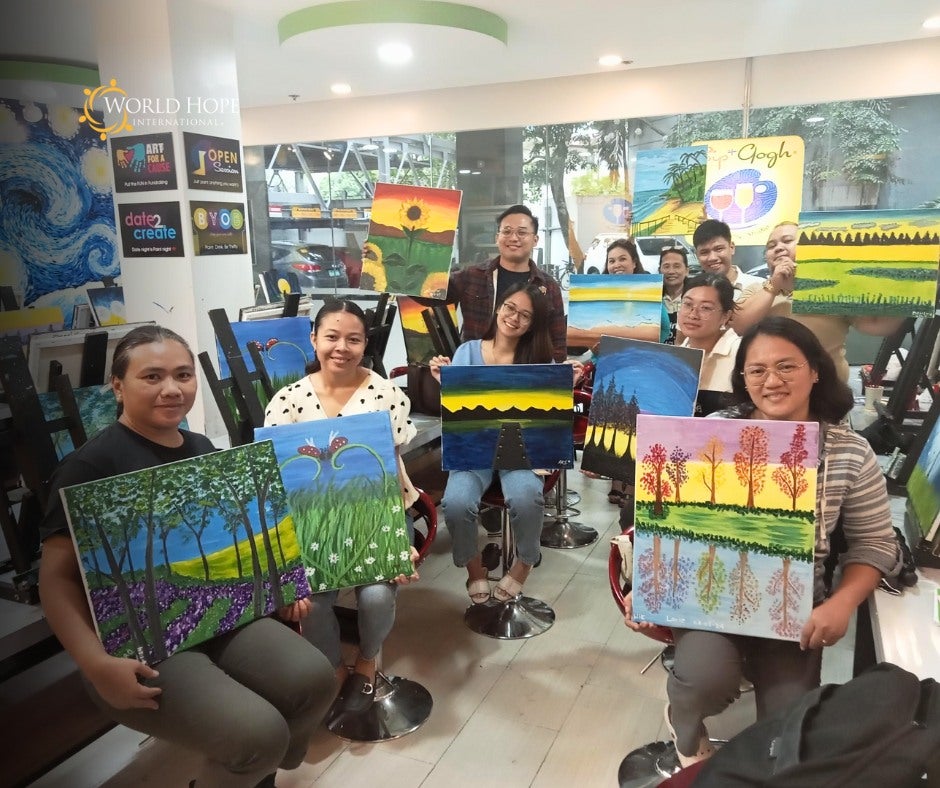 group of Filipino therapists showing their paintings