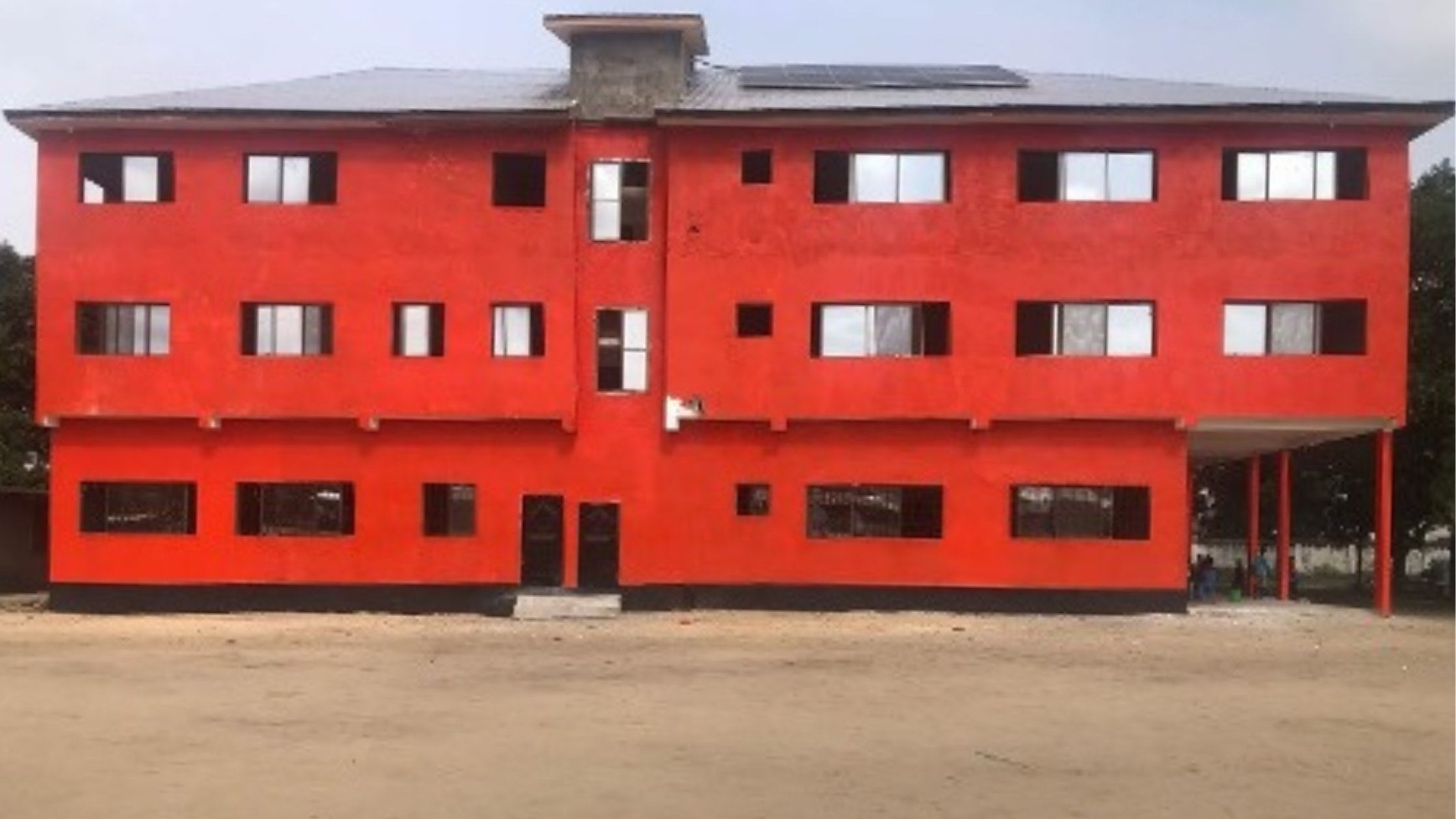 Beacon of Light and Hope (1) orange 3 storey school in Liberia