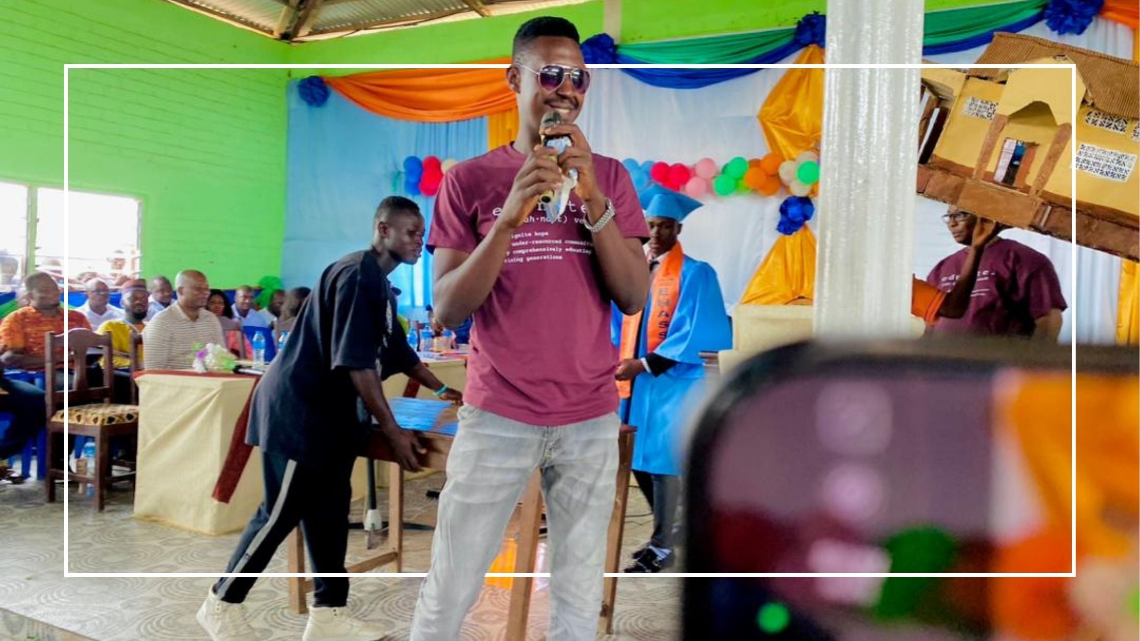 Increase Opportunity through Education Young man with sunglasses and microphone