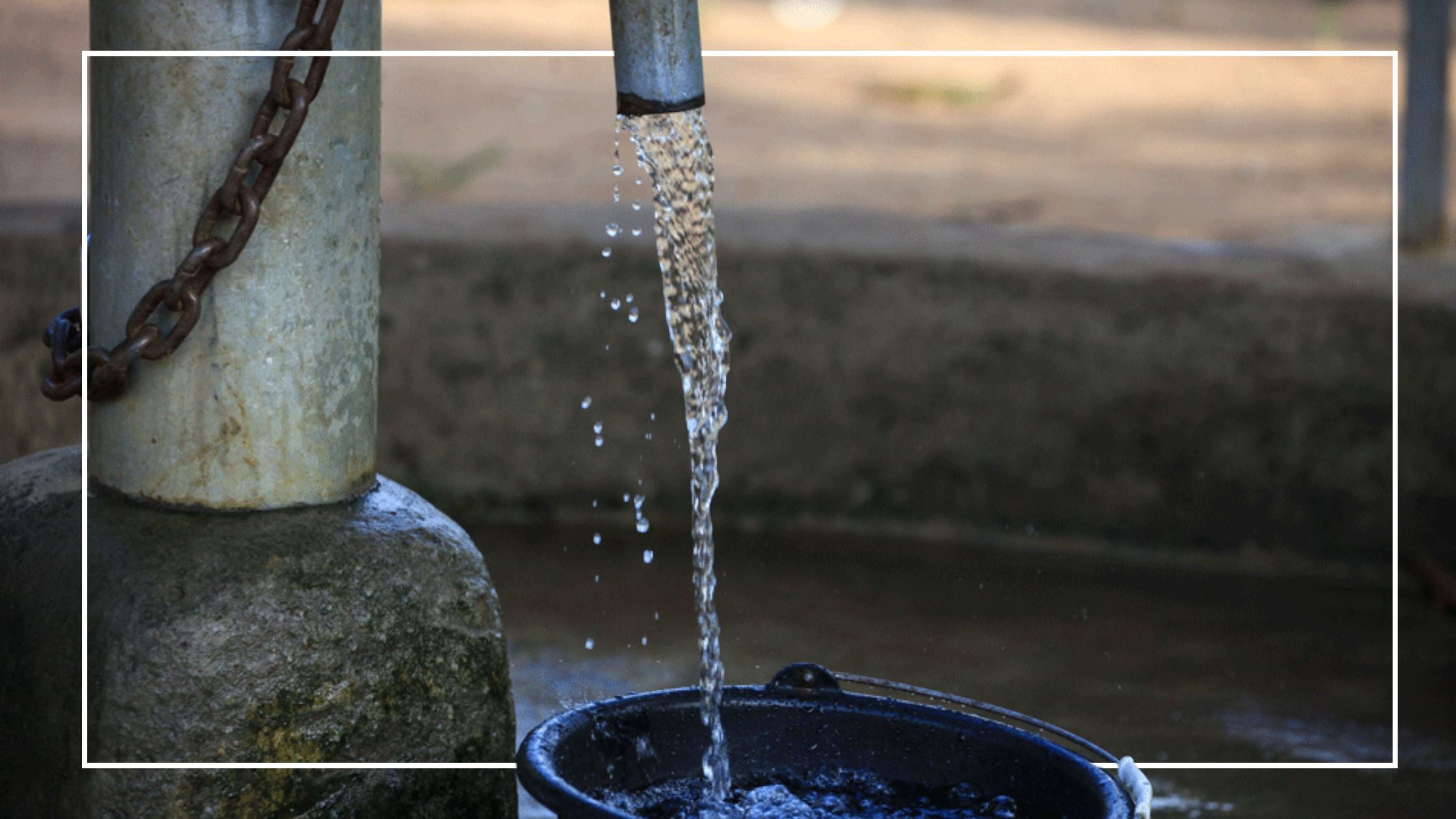 water flowing from a spout into a bucket