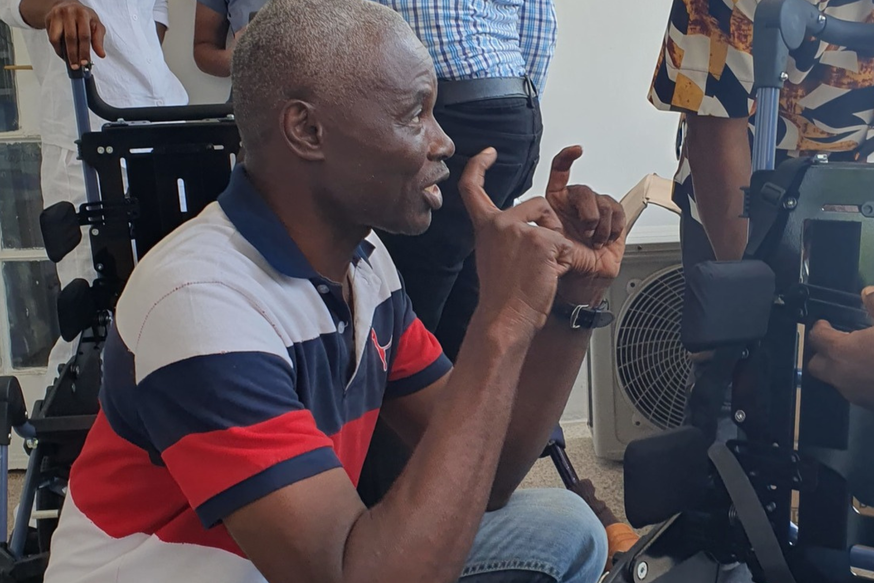 Man learning how to fit wheelchairs properly