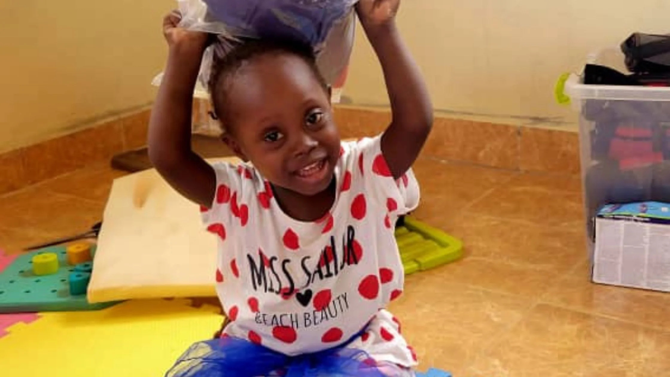 African girl with hands over her head